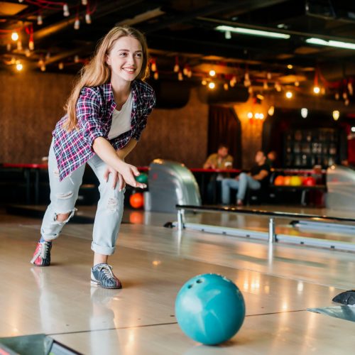 young-woman-playing-with-bowling-ball